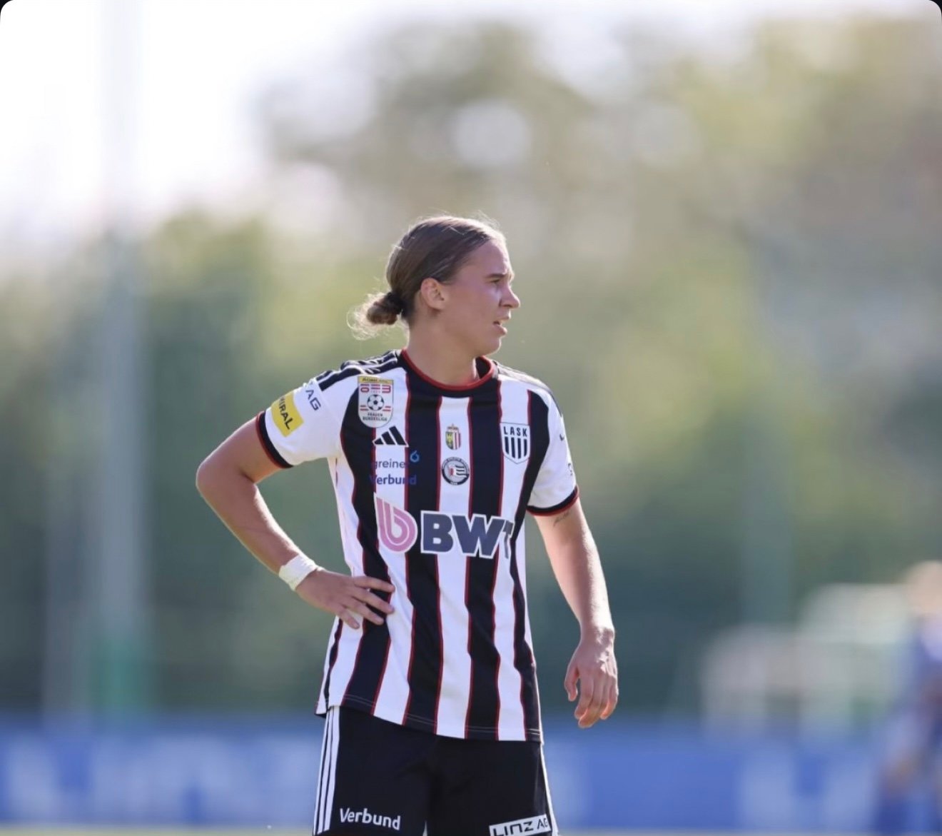 Footballer in a black and white kit during a match
